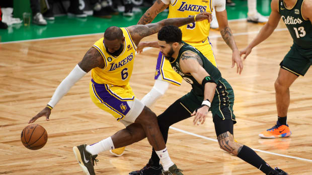Celtics forward Jayson Tatum defends Lakers forward LeBron James.